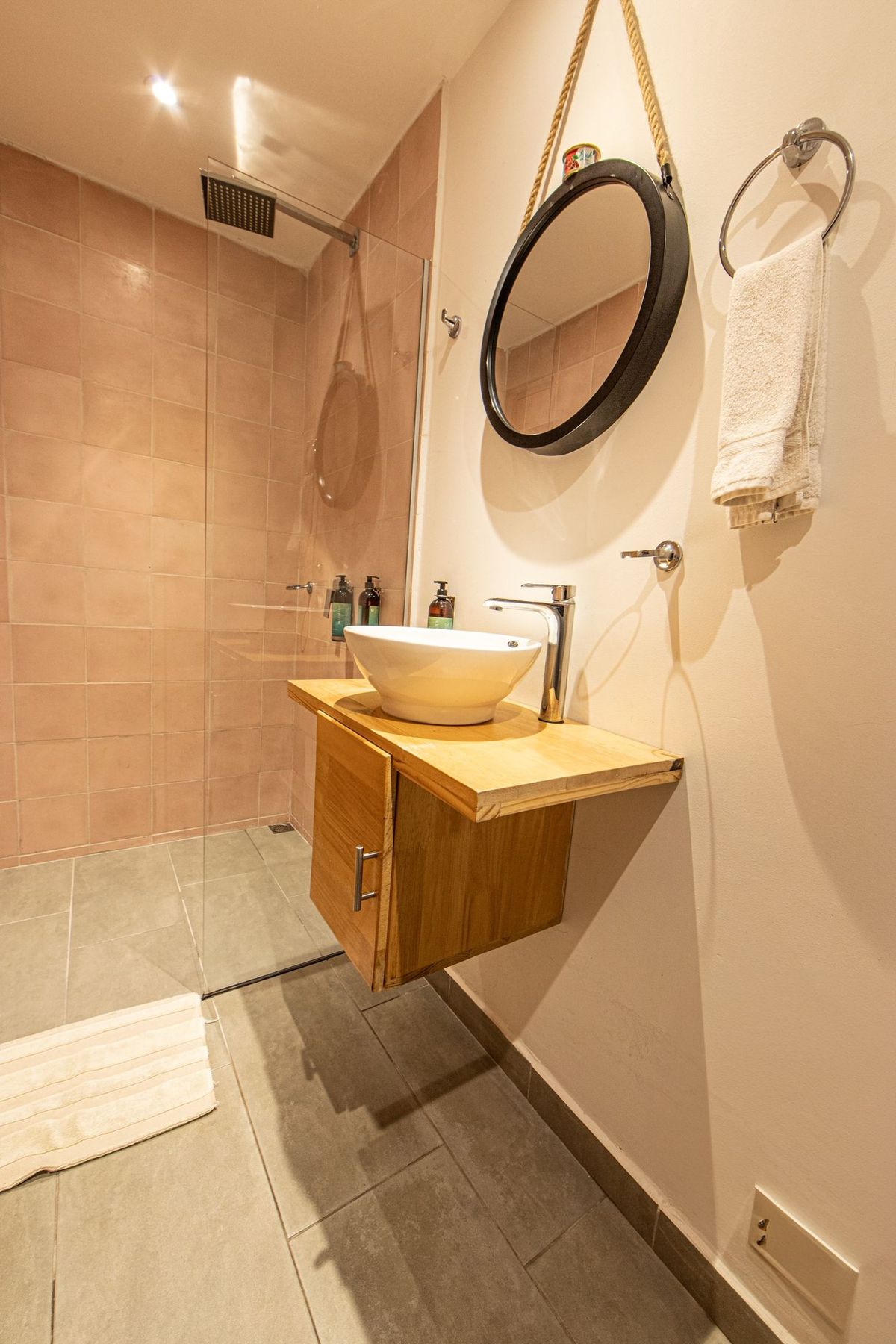 A pink-tiled private bathroom.