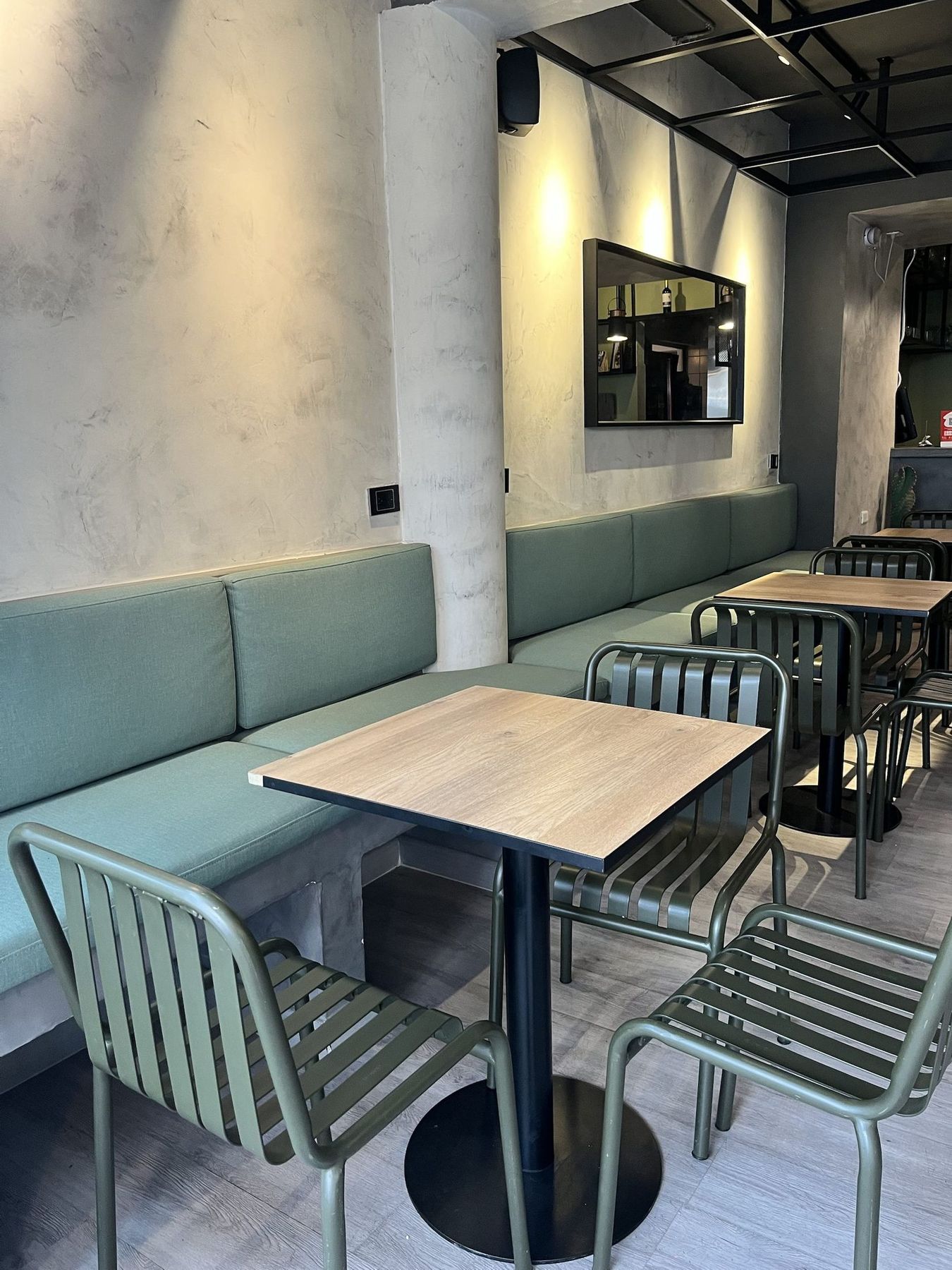 The long banquette with warm wall lights.