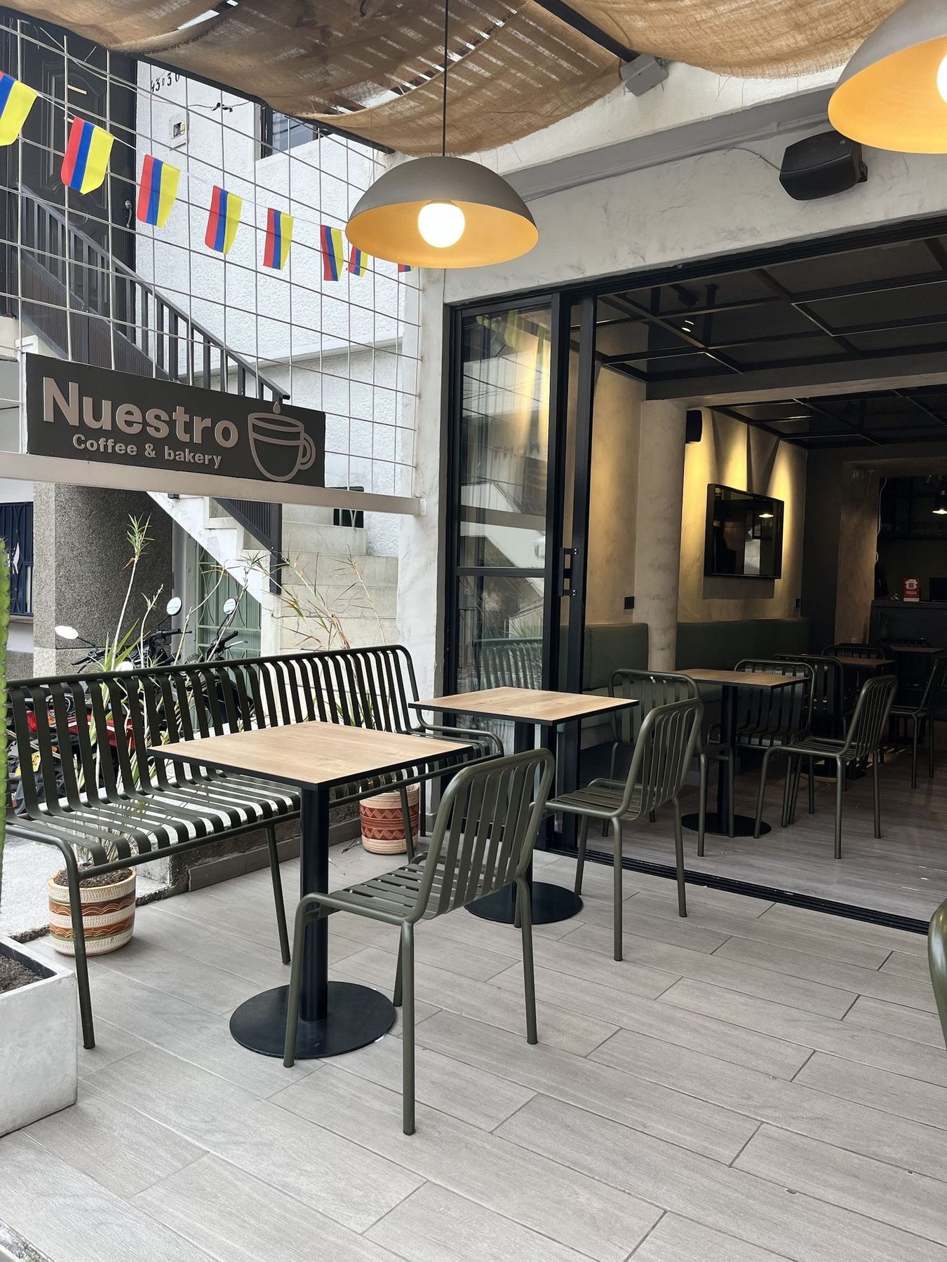 The café terrace under the shade cloth.