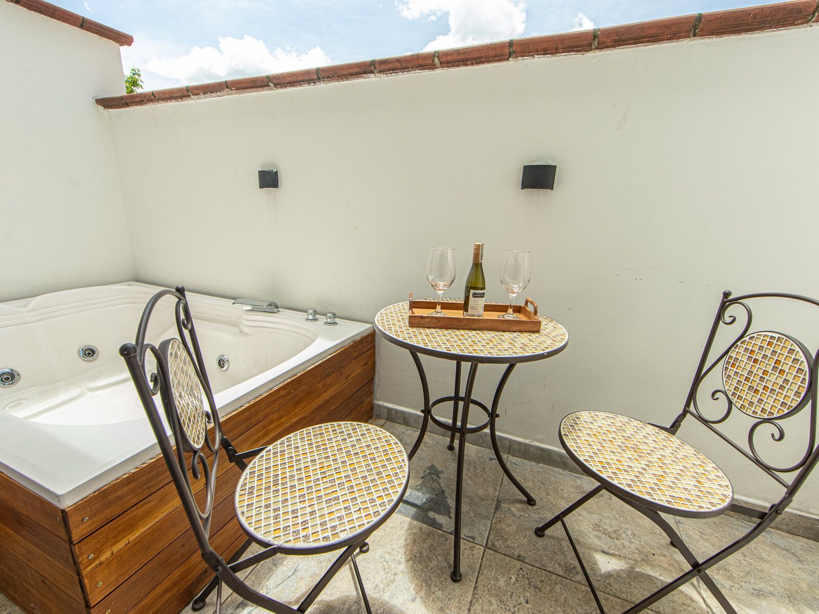 A private balcony with its own hot tub and a bistro table.