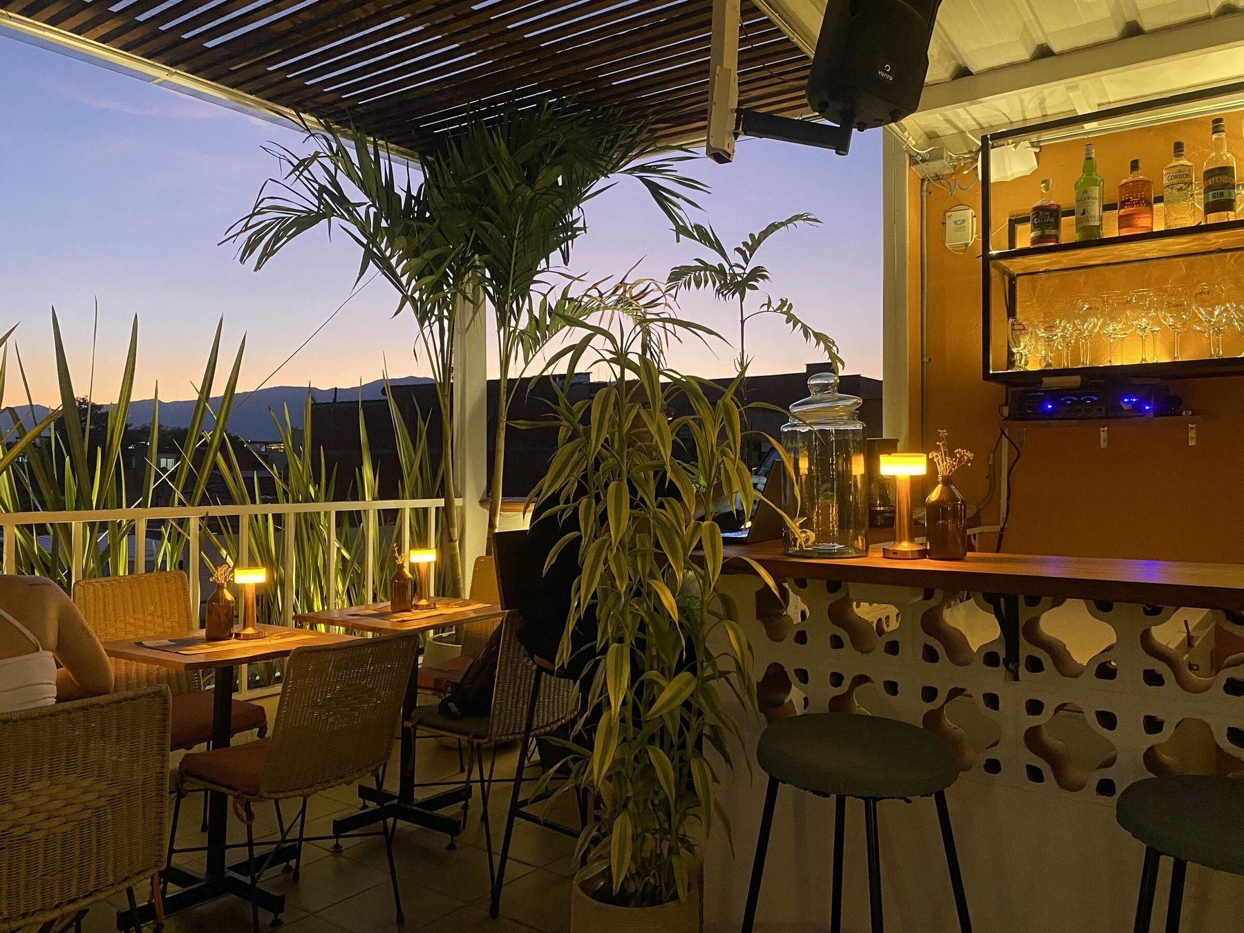 The bar at sunset with the city behind.