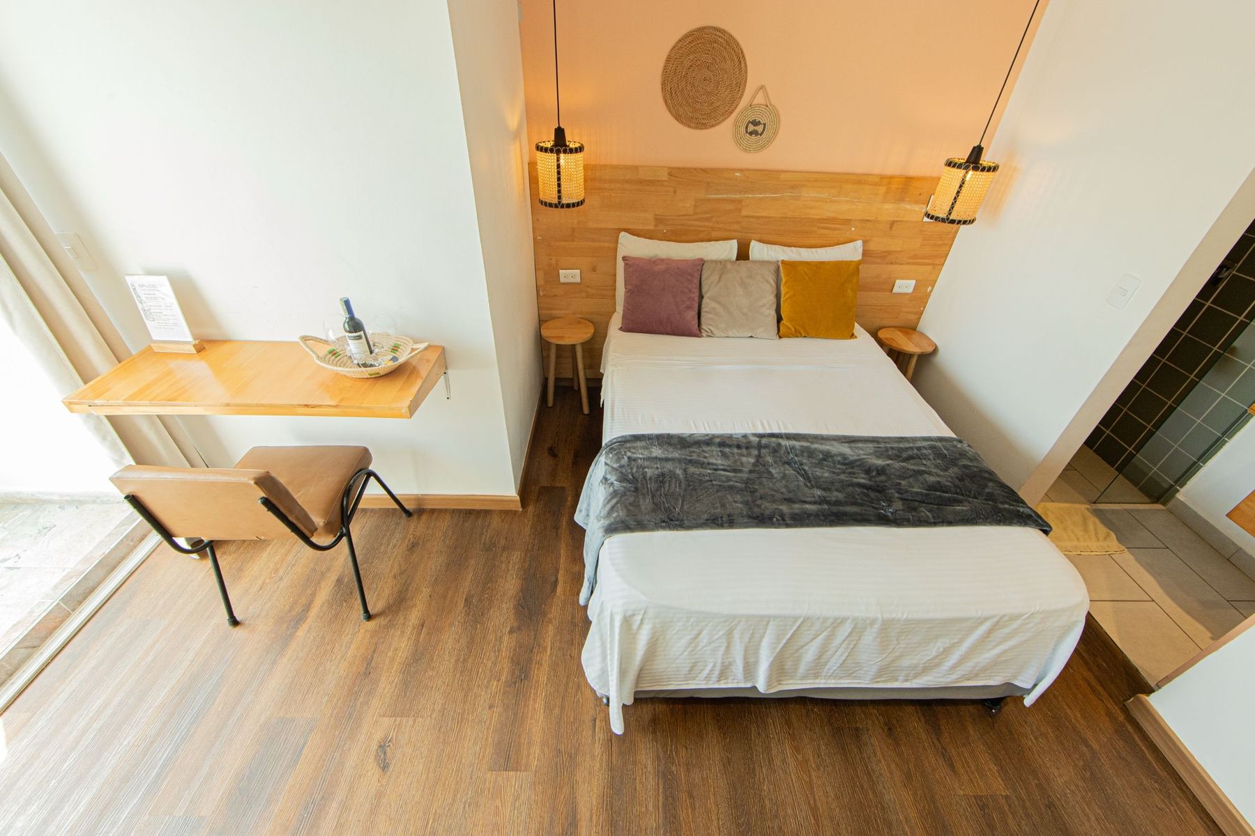 A room with a writing desk by the balcony door.